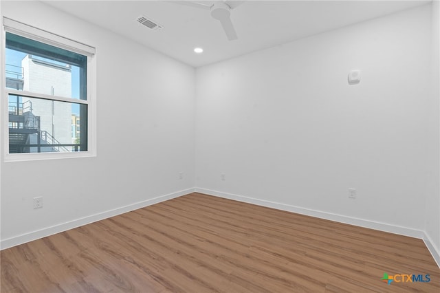 unfurnished room featuring ceiling fan and hardwood / wood-style floors