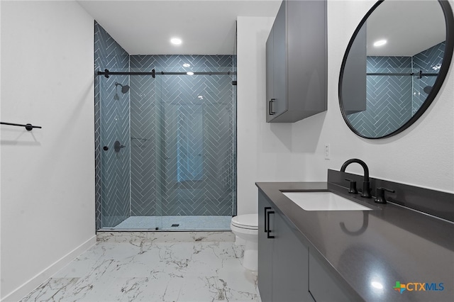 bathroom with an enclosed shower, vanity, and toilet