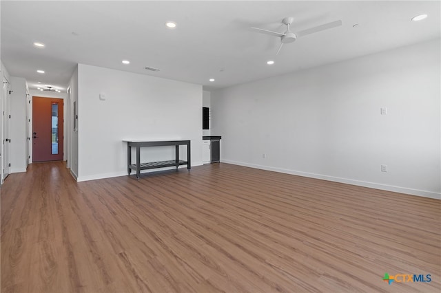 unfurnished living room with ceiling fan and light hardwood / wood-style floors