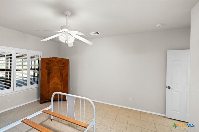 bedroom with ceiling fan and light tile patterned floors