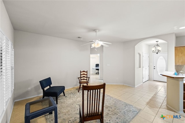 dining area with ceiling fan with notable chandelier and light tile patterned flooring