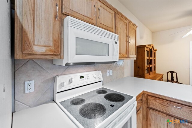 kitchen with decorative backsplash, white appliances, and ceiling fan