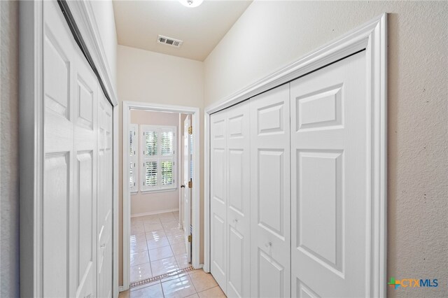 corridor with light tile patterned floors