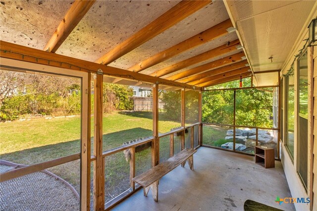 unfurnished sunroom featuring lofted ceiling