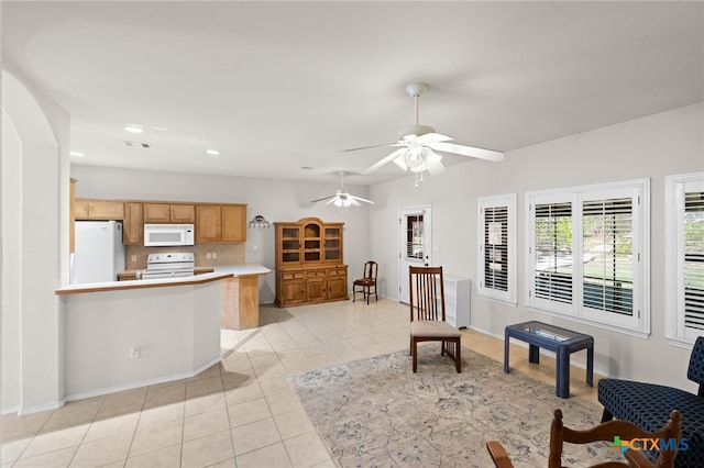 tiled living room with ceiling fan