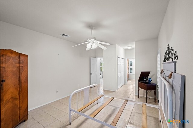 interior space with ceiling fan