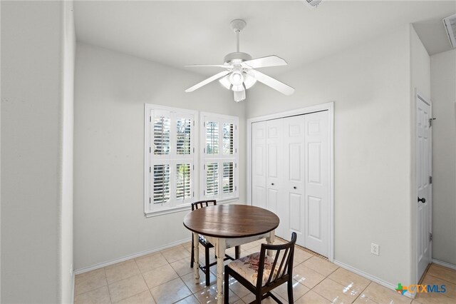 tiled dining space featuring ceiling fan