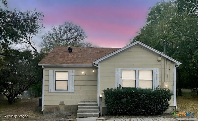 bungalow-style house with crawl space and roof with shingles