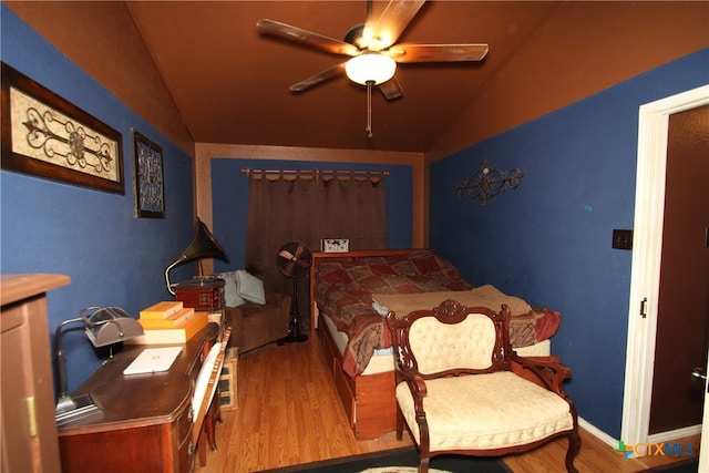 bedroom featuring hardwood / wood-style flooring, ceiling fan, and lofted ceiling