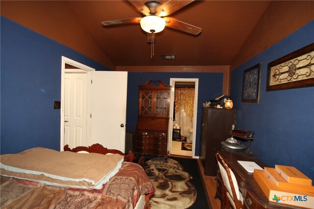 bedroom featuring hardwood / wood-style flooring, ceiling fan, and vaulted ceiling