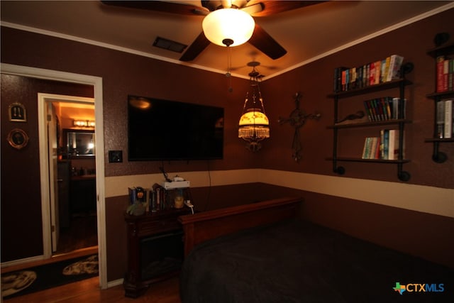 bedroom featuring hardwood / wood-style floors and crown molding