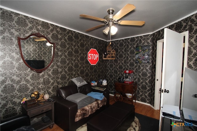 bedroom with hardwood / wood-style floors, ceiling fan, and ornamental molding