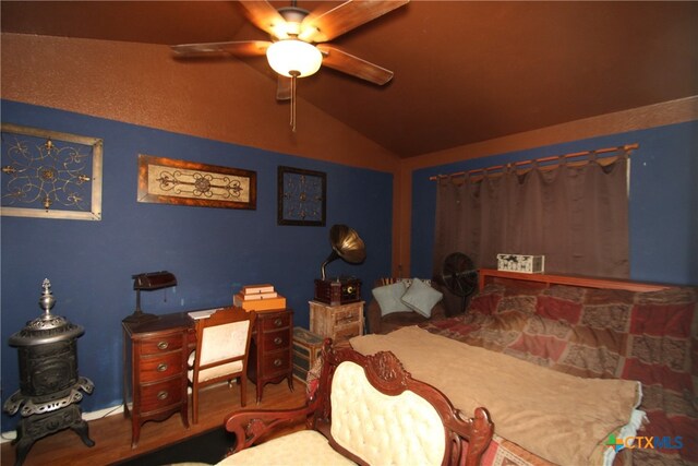 bedroom featuring lofted ceiling, wood-type flooring, and ceiling fan