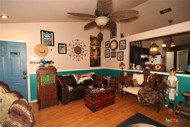 living room featuring hardwood / wood-style floors, ceiling fan, and lofted ceiling