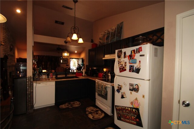 kitchen with sink, kitchen peninsula, backsplash, hanging light fixtures, and white appliances