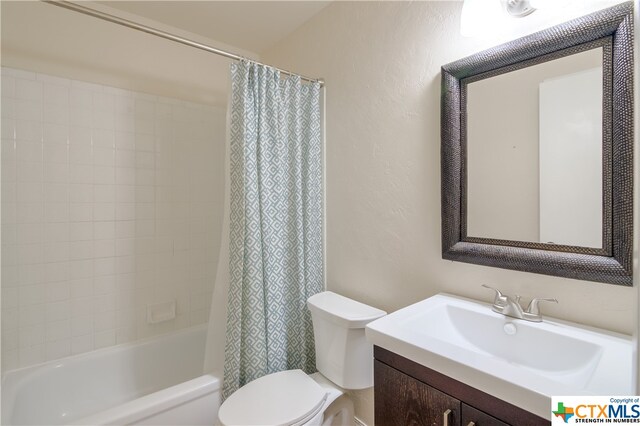 full bathroom featuring vanity, toilet, and shower / bath combination with curtain