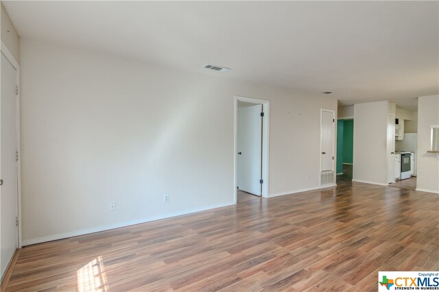 unfurnished living room featuring hardwood / wood-style floors