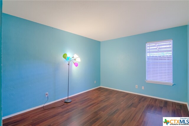 spare room featuring dark hardwood / wood-style floors