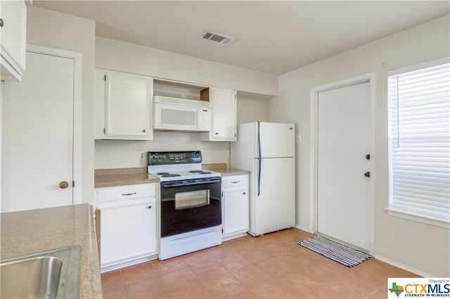 kitchen featuring white cabinetry and white appliances