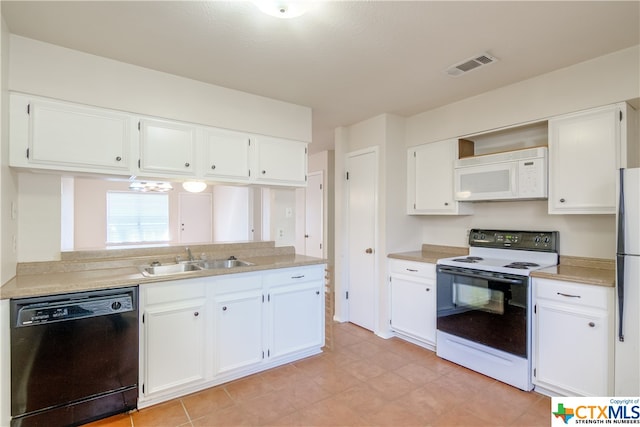 kitchen with white appliances, white cabinetry, and sink