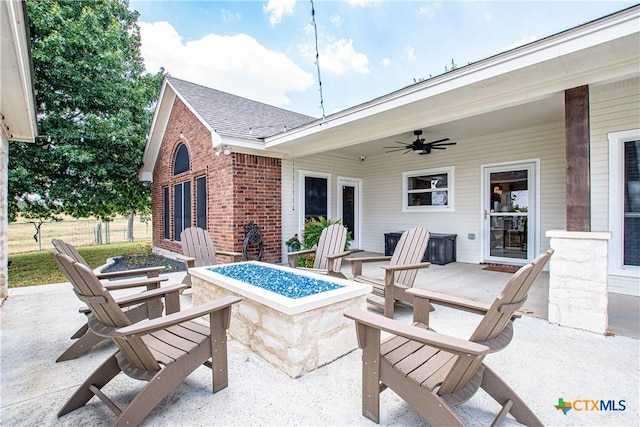 view of patio / terrace with an outdoor fire pit and ceiling fan