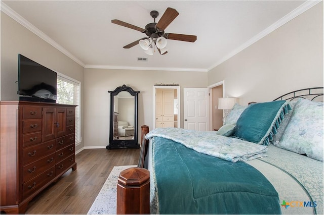 bedroom with ceiling fan, dark hardwood / wood-style floors, and ornamental molding