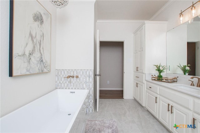 bathroom with vanity, a tub to relax in, and crown molding