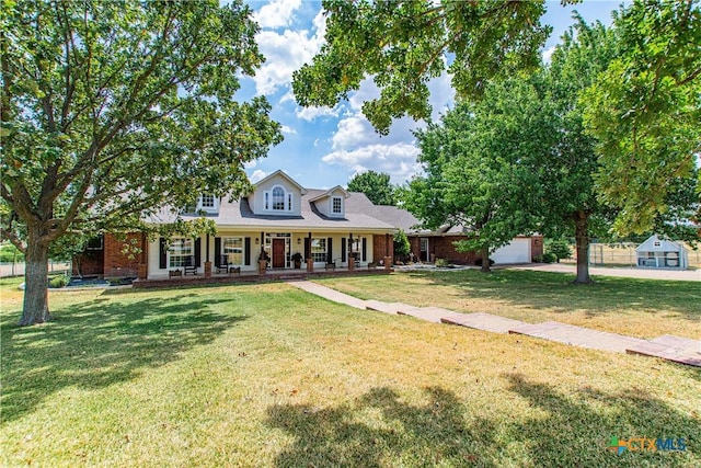 cape cod home featuring a porch and a front yard