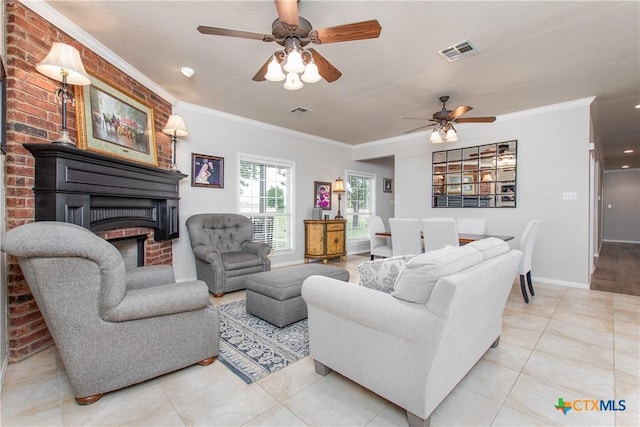 tiled living room with ceiling fan, crown molding, and a brick fireplace