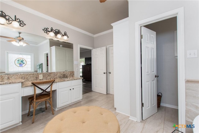 bathroom with ceiling fan, ornamental molding, and vanity