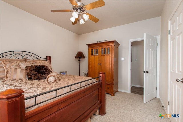 bedroom featuring ceiling fan and light carpet