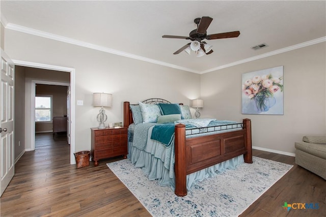 bedroom with ceiling fan, dark hardwood / wood-style flooring, and ornamental molding