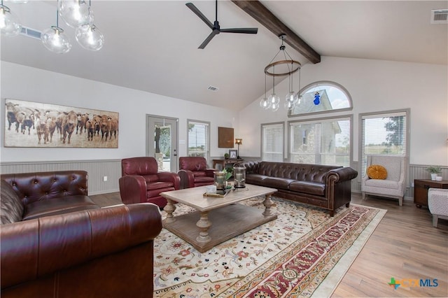 living room featuring ceiling fan, light hardwood / wood-style flooring, beamed ceiling, and high vaulted ceiling