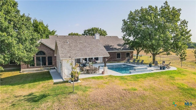 back of house featuring a patio area and a lawn