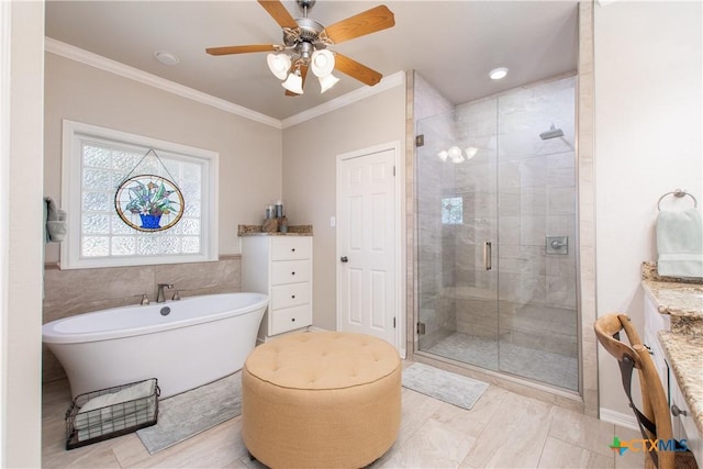 bathroom with ornamental molding, vanity, ceiling fan, and independent shower and bath