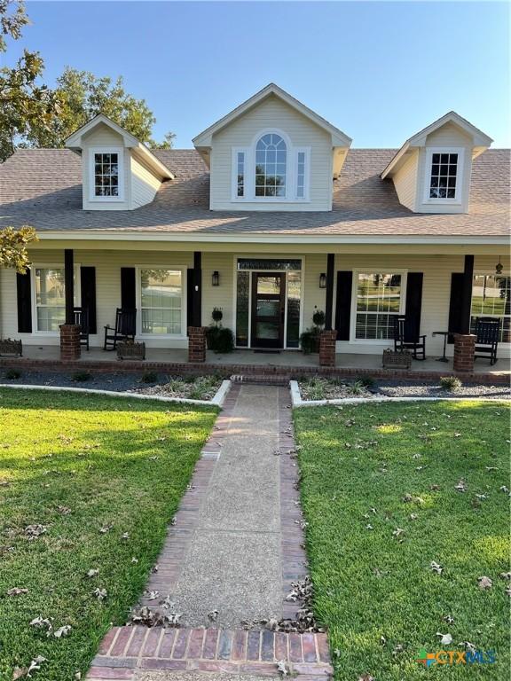 view of front facade with covered porch and a front lawn