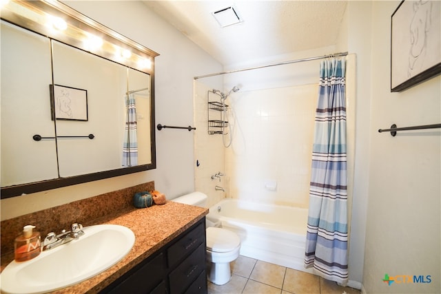 full bathroom featuring shower / bath combination with curtain, tile patterned floors, vanity, a textured ceiling, and toilet