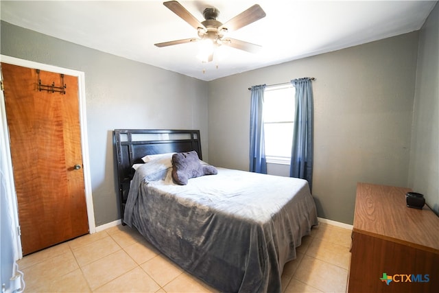 bedroom with ceiling fan and light tile patterned floors