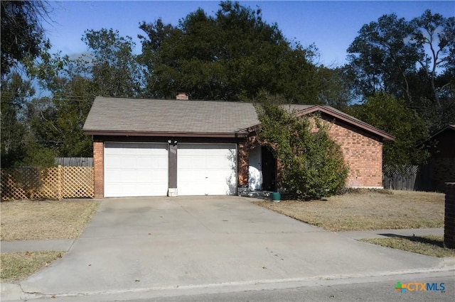 1106 Dryden Ave, Copperas Cove, TX 76522 - view of front of home featuring brick siding, an attached garage, concrete driveway, and a chimney