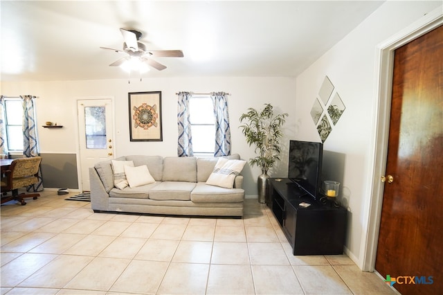 living room featuring a wealth of natural light, ceiling fan, and light tile patterned floors