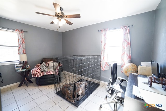 home office featuring ceiling fan and light tile patterned floors