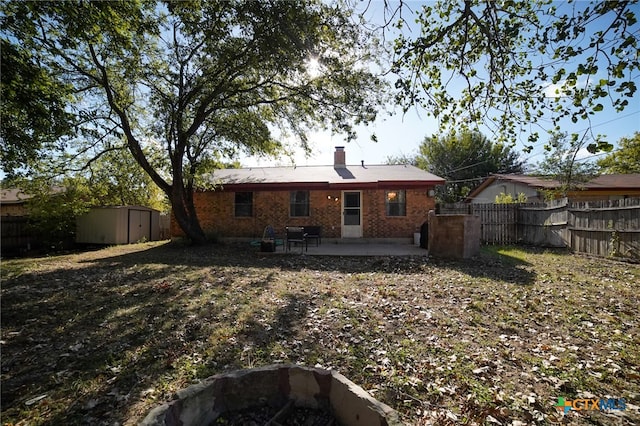 back of house with a patio area and a shed