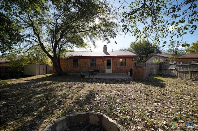 1106 Dryden Ave, Copperas Cove, TX 76522 - back of property featuring a patio, a storage unit, a fenced backyard, brick siding, and a chimney
