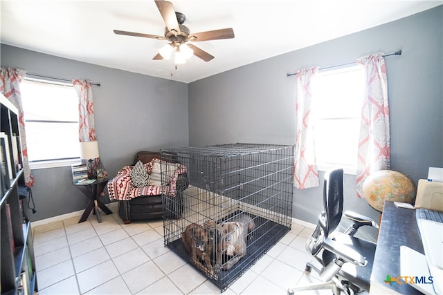 tiled bedroom featuring ceiling fan