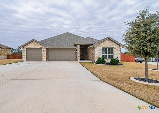 view of front of home featuring a garage and a front lawn