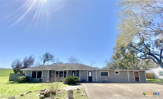 ranch-style house with fence and a front yard