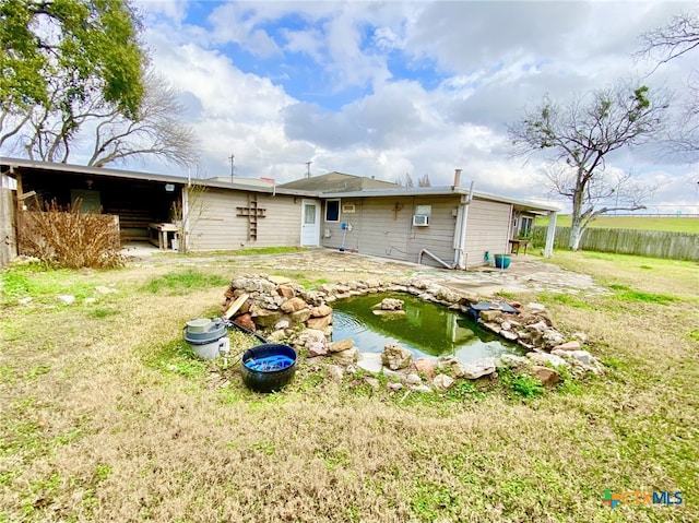 rear view of property featuring a yard