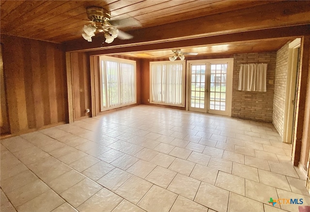 empty room with ceiling fan, wooden ceiling, and a healthy amount of sunlight