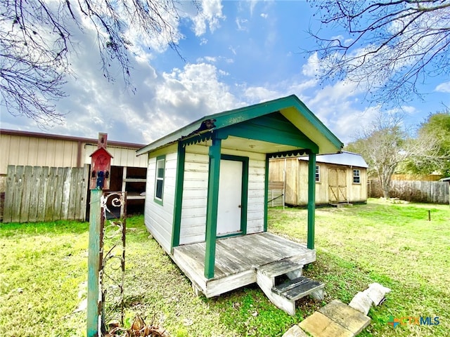 view of shed featuring fence