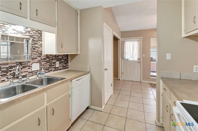 105 Concord Ln, Victoria, TX 77901 - kitchen featuring white appliances, light tile patterned floors, backsplash, a sink, and light countertops